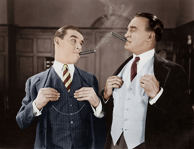 Two men smoking cigars